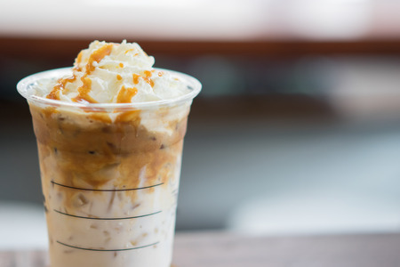 Ice coffee and whipped cream with caramel sauce.の写真素材