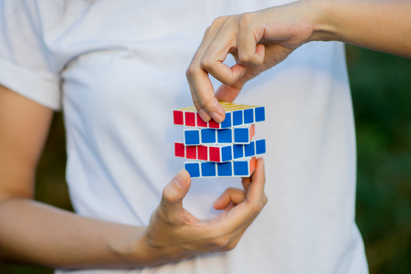Bangkok, Thailand - November 10, 2017: woman wearing casual clothes collect Rubik's Cube. Rubik's cube invented by a Hungarian architect Erno Rubik in 1974.のeditorial素材