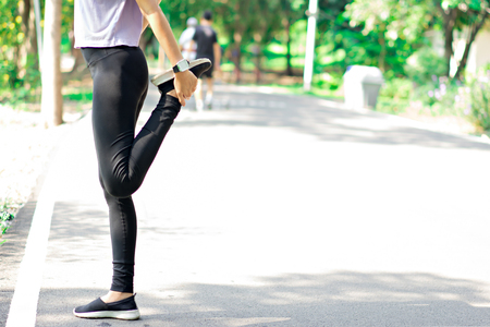 Women are stretching Before jogging in the park.  Workout concept.の写真素材