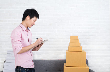 Asia man working business SME online at home. Start small trade conceptの写真素材