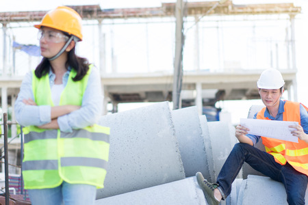 Male Engineering wearing yellow helmet and working at construction site