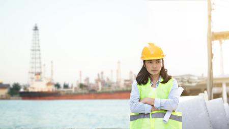 Engineering wearing yellow helmet and working at construction site about transportation of international logistics backgroundの写真素材