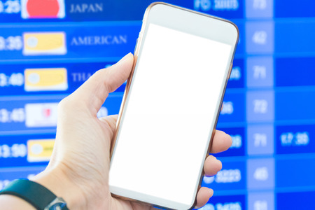 Blurred hand holding smart phone for checking fight for transit in airportの写真素材