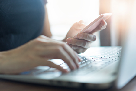Business people using laptop and smartphone for working onlineの写真素材