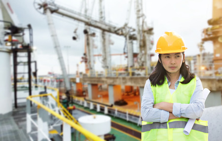 Women Engineering wearing hard hat and working at construction site