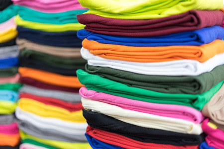 Stack T-shirts on shelf in a shop