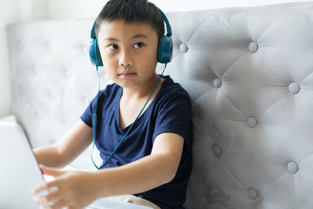 Little boy using laptop play game at home for relax