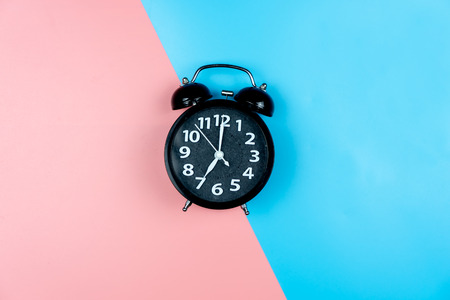 Alarm clock on color background.
