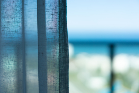 Curtain at the window in the morning.  Sea view conceptの写真素材