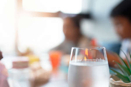 Cold water in glass on dinner table