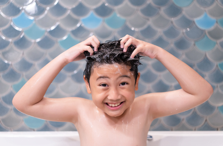 Little boy happy in shower at bathroom