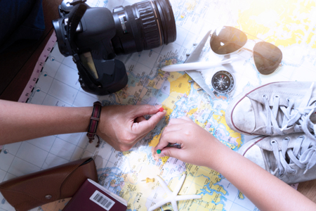 Hand to planning vacation trip and accessories for travelの写真素材