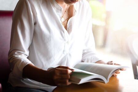 Hand holding a book at home