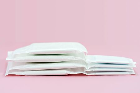 Stacked sanitary napkin pad on pink background.の写真素材