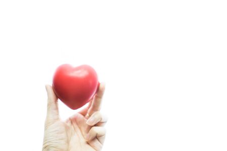Hand holding heart shape on isolated white.  Health conceptの写真素材