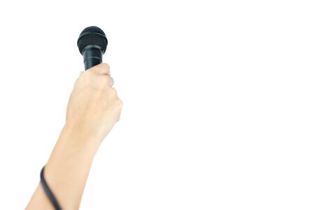 Black microphone with hand on isolated whiteの写真素材