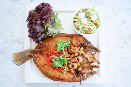 Fried fish with spicy salad.  Thai food styleの写真素材