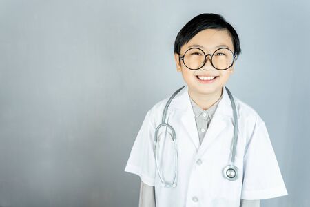 Little boy and stethoscope in doctor uniform with copy space.の写真素材