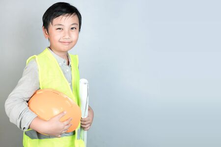 Little boy in engineering uniform with helmet and copy spaceの写真素材