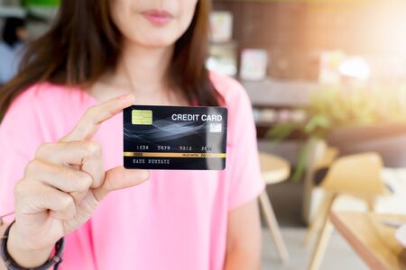 Pretty woman showing credit card for business onlineの写真素材
