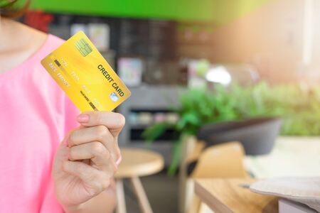 Hand woman showing credit card for business online