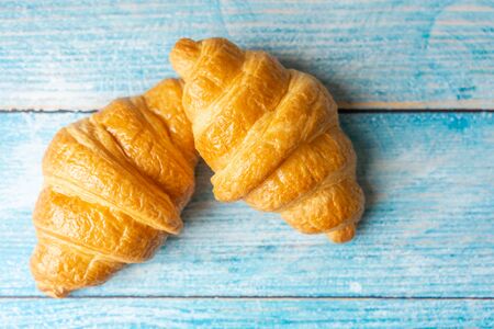 Croissant pile on wooden backgroundの写真素材