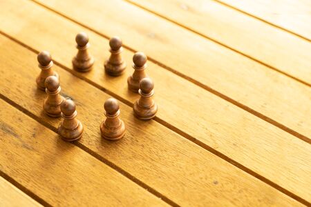 Business teamwork concept.  Chess pieces on wooden background