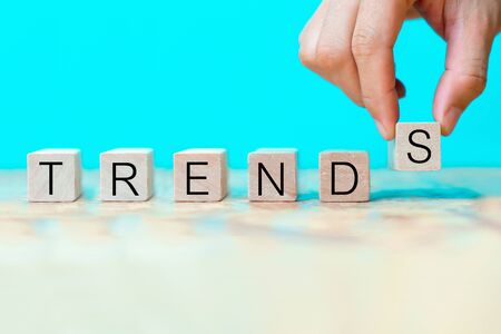 Word trends on wooden blocks with handの写真素材