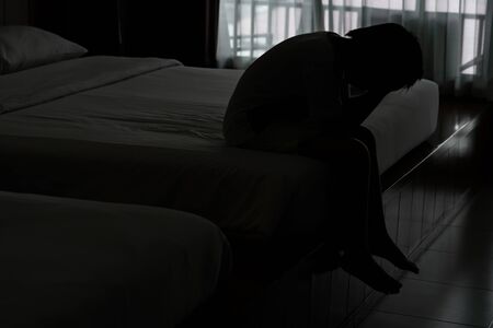 Little boy feel sad in bed roomの写真素材