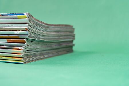 Stack magazines on green background