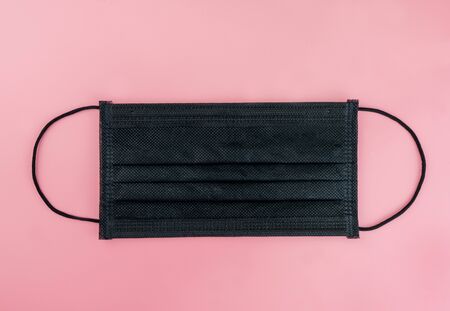 Health masks of black on pink backgroundの写真素材