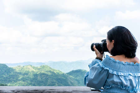 Tourists taking photo of natural sceneryの写真素材