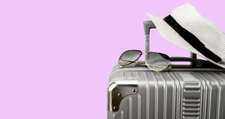 Travel bag with accessories on color background