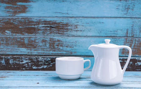 Set of white teacups on a blue wooden floorの写真素材