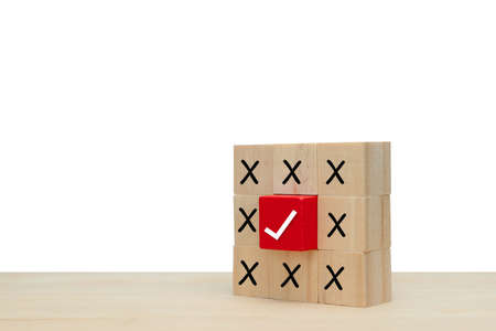 True and false or Yes or No symbols on wood blog on yellow and grey background.の写真素材