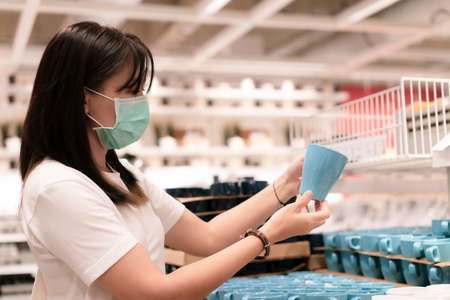 New normal shopping.  Asian woman shopping furniture for decorate home