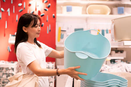 Asian woman shopping furniture for decorate home