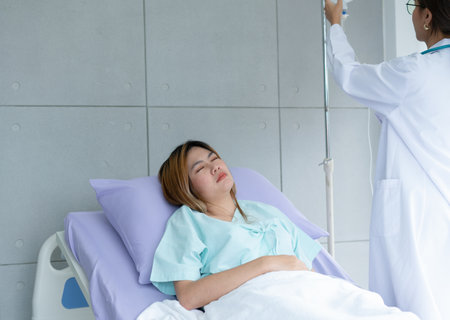 Woman patient lies on the bed and receives saline from the doctor.