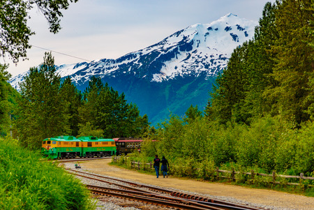 Skagway, Alaska, USA - September 13, 2016:  This historic railroad system makes daily scenic excursions over rugged terrain overlooking mountains, gorges, glaciers, waterfalls, forests, trestles and tunnels.のeditorial素材