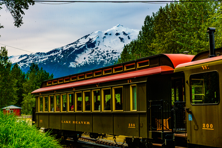 Skagway, Alaska, USA - September 13, 2016:  This historic railroad system makes daily scenic excursions over rugged terrain overlooking mountains, gorges, glaciers, waterfalls, forests, trestles and tunnels.のeditorial素材