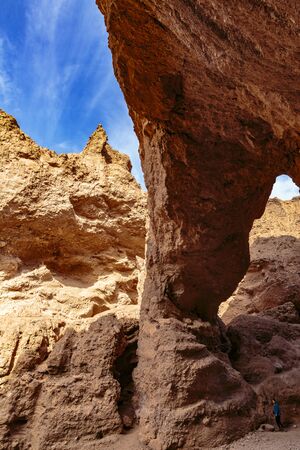 Death Valley, California, USA - December 17, 2018:  Red rock formatioins in a narrow river canyon form a cool Natural Bridge hiking attraction in Death Valley National Park.のeditorial素材