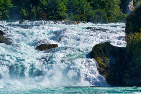 the famous rhine falls in the swiss near the city of Schaffhausen - sunny day and blue skyの写真素材