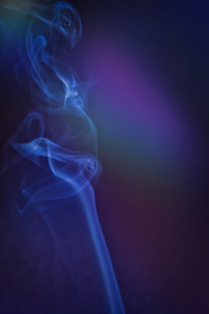 Smoky clouds on blue and black backgroundの写真素材