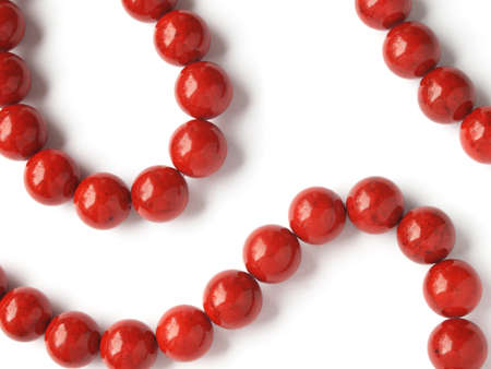 Glossy red coral beads on white backgroundの写真素材