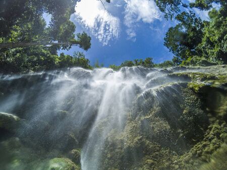Under the amazing waterfall full of light