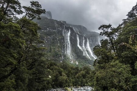 So many amazing waterfalls in a mountains during rainy day falling from a steep rocksの写真素材