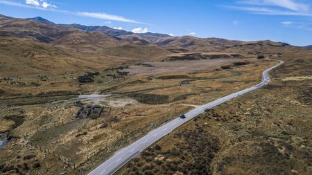 Car on the road in the middle of nowhere aerial viewの写真素材