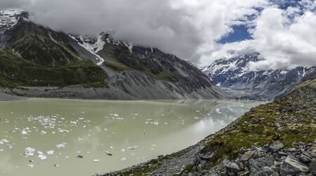 Glacier lake with pieces of an ice in a mountainsの写真素材