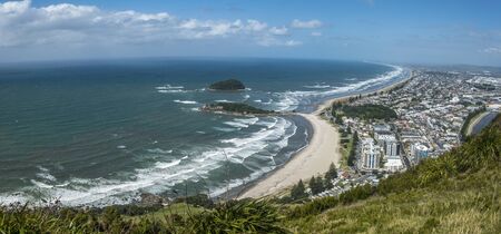 Sandy beach blue ocean and coastal town from the mountain view