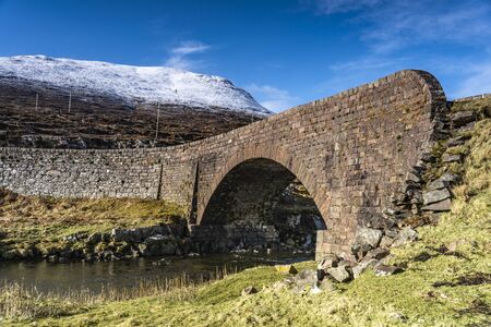 Historical stone bridge over the river during sunny dayの写真素材